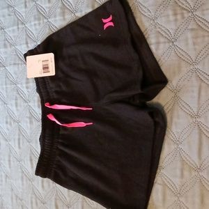 Hurley girl's shorts size M, black with pink ties and logo.